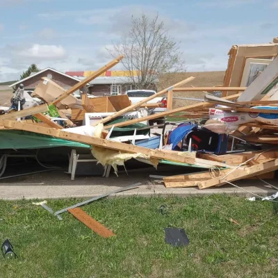 Tornado damage in Omaha home with collapsed framing and debris, documented for insurance claim and storm repair rebuild.