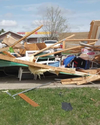 Tornado damage in Omaha home with collapsed framing and debris, documented for insurance claim and storm repair rebuild.