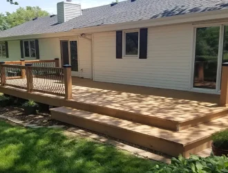 Large composite deck with steps and custom railing, backyard renovation in Nebraska