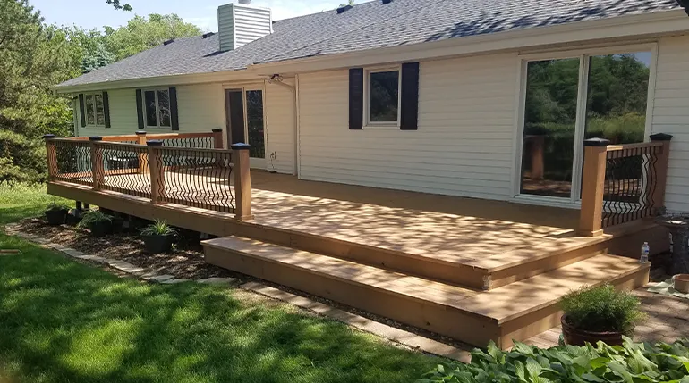 Large composite deck with steps and custom railing, backyard renovation in Nebraska