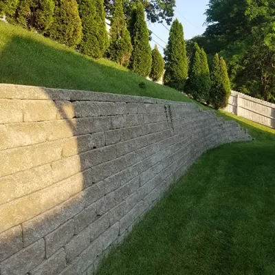 Finished retaining wall in Omaha providing slope stability and landscaping support by Liberty Contractors