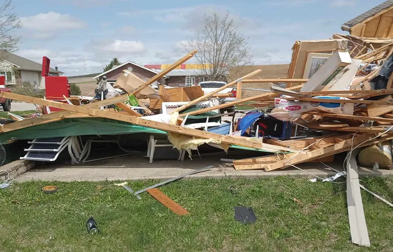 Tornado damage in Omaha home with collapsed framing and debris, documented for insurance claim and storm repair rebuild.