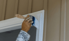 House painter in Omaha using brush for precise trim and detail painting