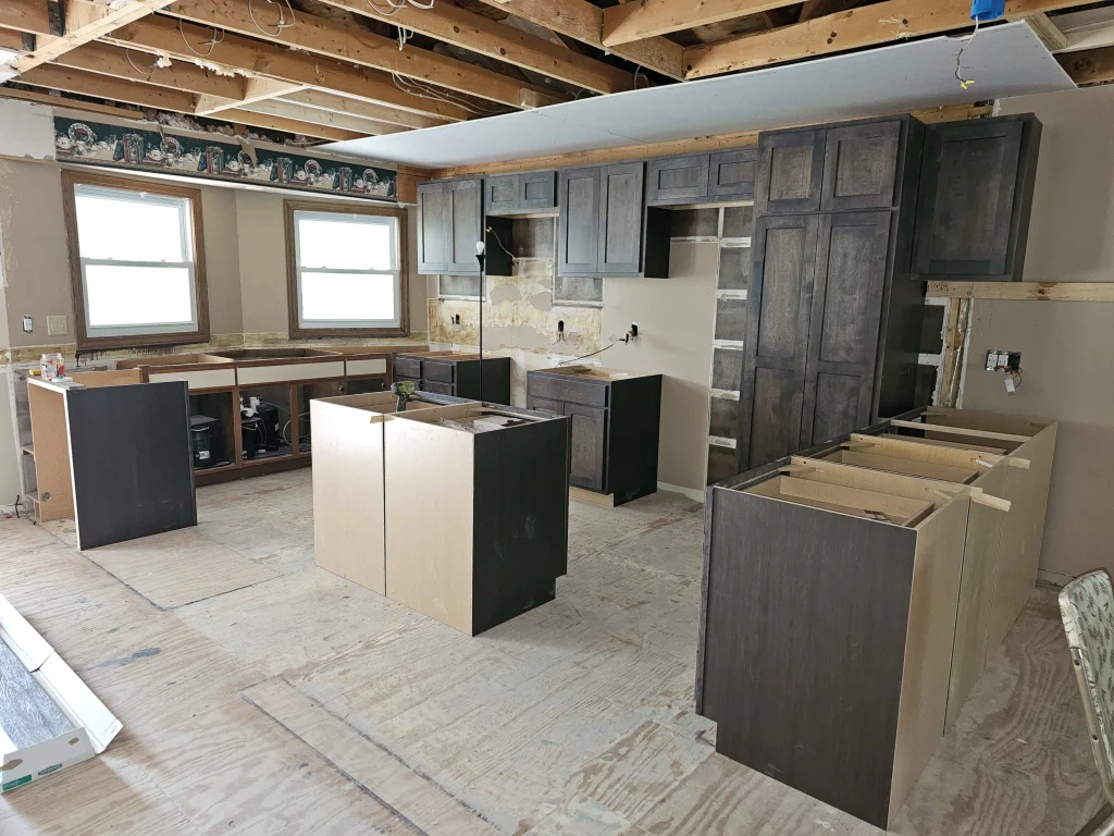 A new start to a new kitchen remodel. Showing bare beams and new kitchen units