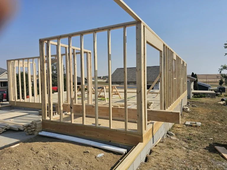 Storm damage insurance rebuild showing new wall framing on residential home.