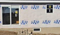 Before windows and doors Omaha project showing home wrapped and prepped for installation.