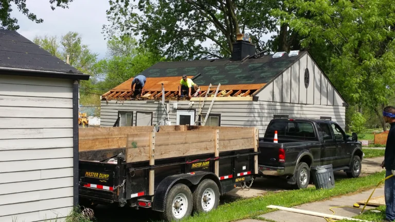 Crew completing a roof tear off during a roofing insurance claim Omaha project on a single story home. Hail storm roof repair