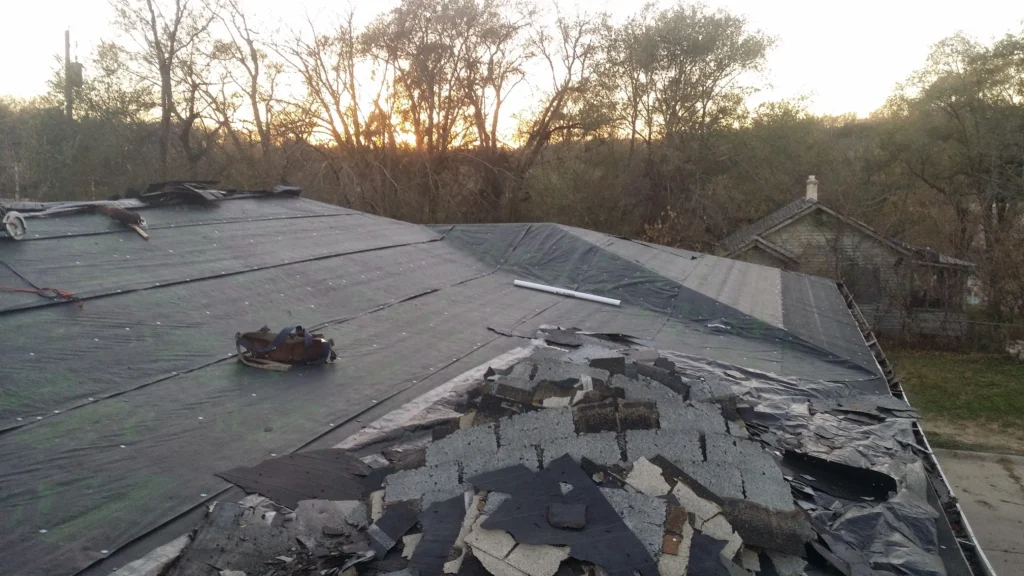 Roofing insurance claim Omaha inspection showing hail damage on shingles.