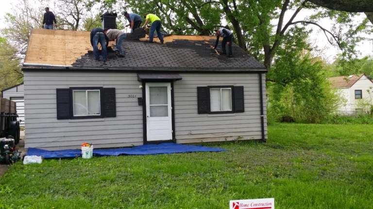 Crew performing hail damage roof repair Omaha during a full tear off on a hail storm damaged roof home repair